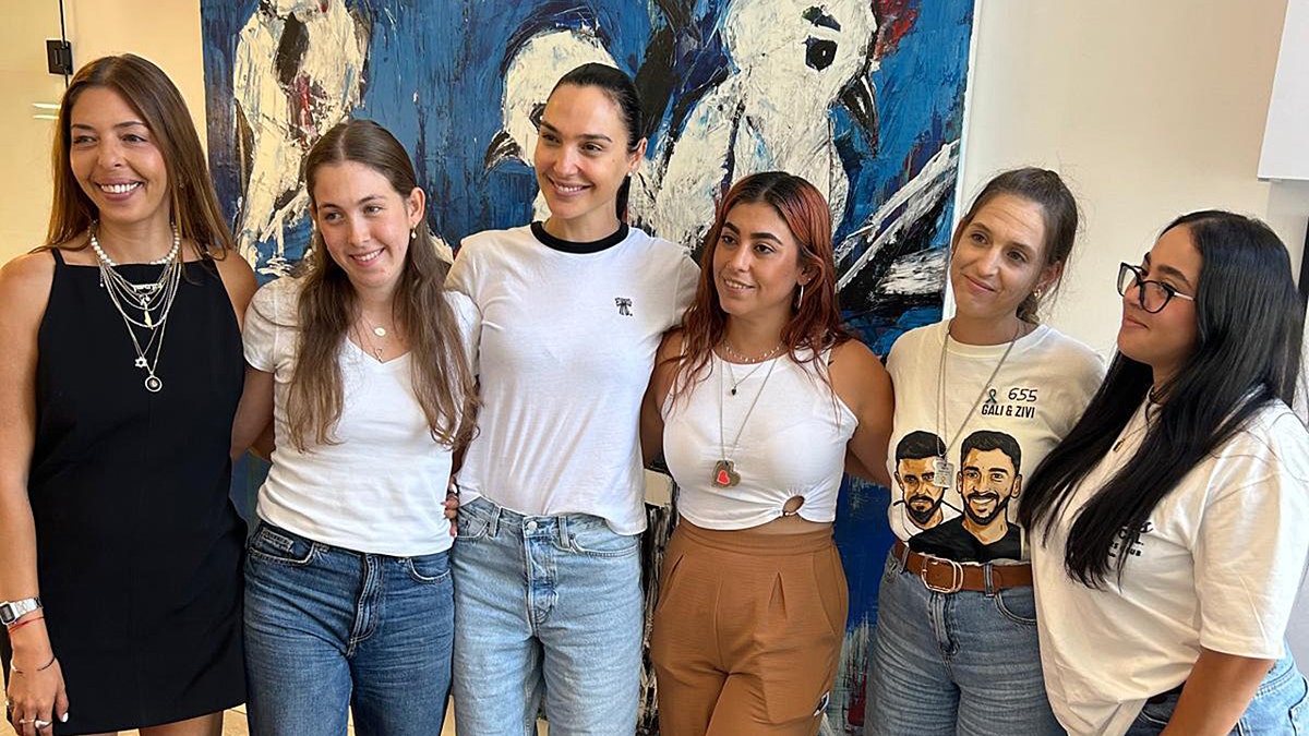 Gal Gadot stands with former Hamas hostages during a visit in Israel
