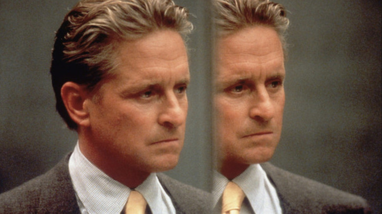 Nicholas Van Orton (Michael Douglas) stares in a mirror in The Game