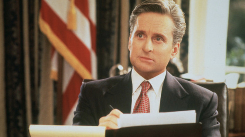 President Andrew Shepherd (Michael Douglas) signs a document in The American President