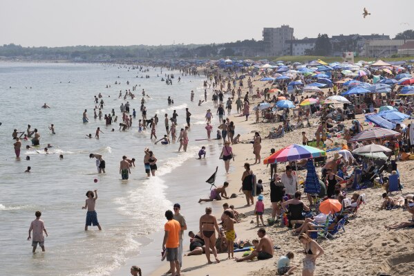 A crowd seeks relief from the heat Tuesday, July 29, 2025, at Old Orchard Beach, Maine. (AP Photo/Robert F. Bukaty)