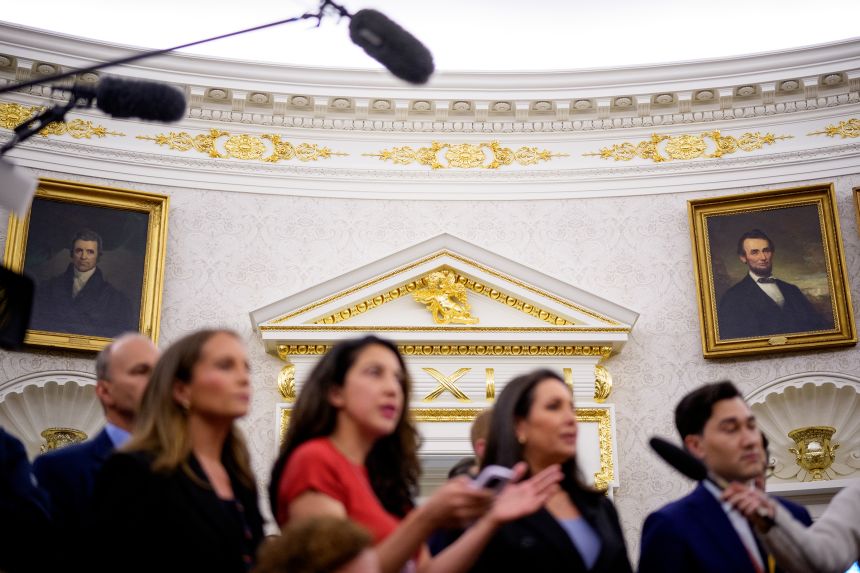 Paintings, gold trim and a cherub statues are seen behind reporters in the Oval Office of the White House on May 28, in Washington, DC.