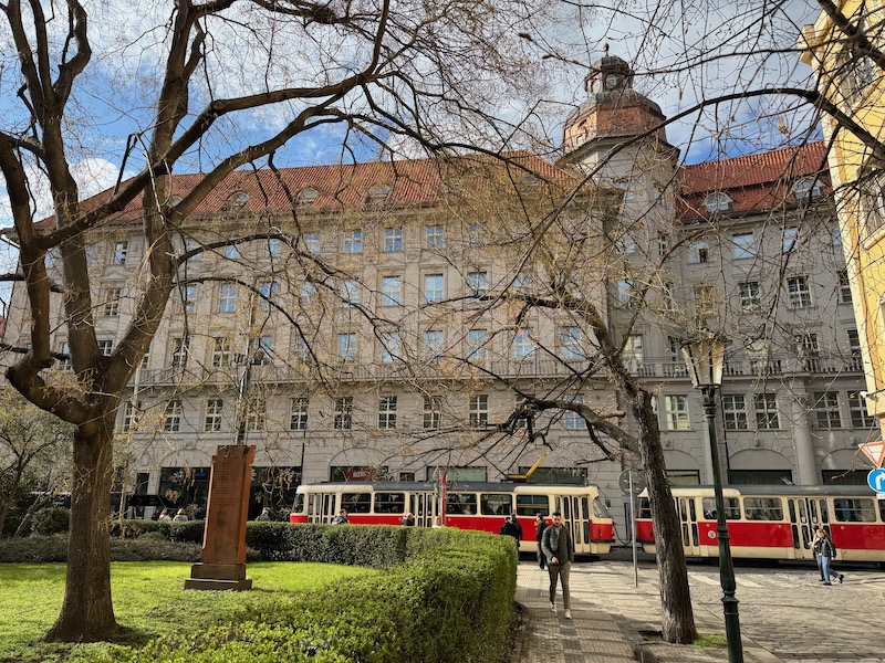 a building with a red and white train in the background