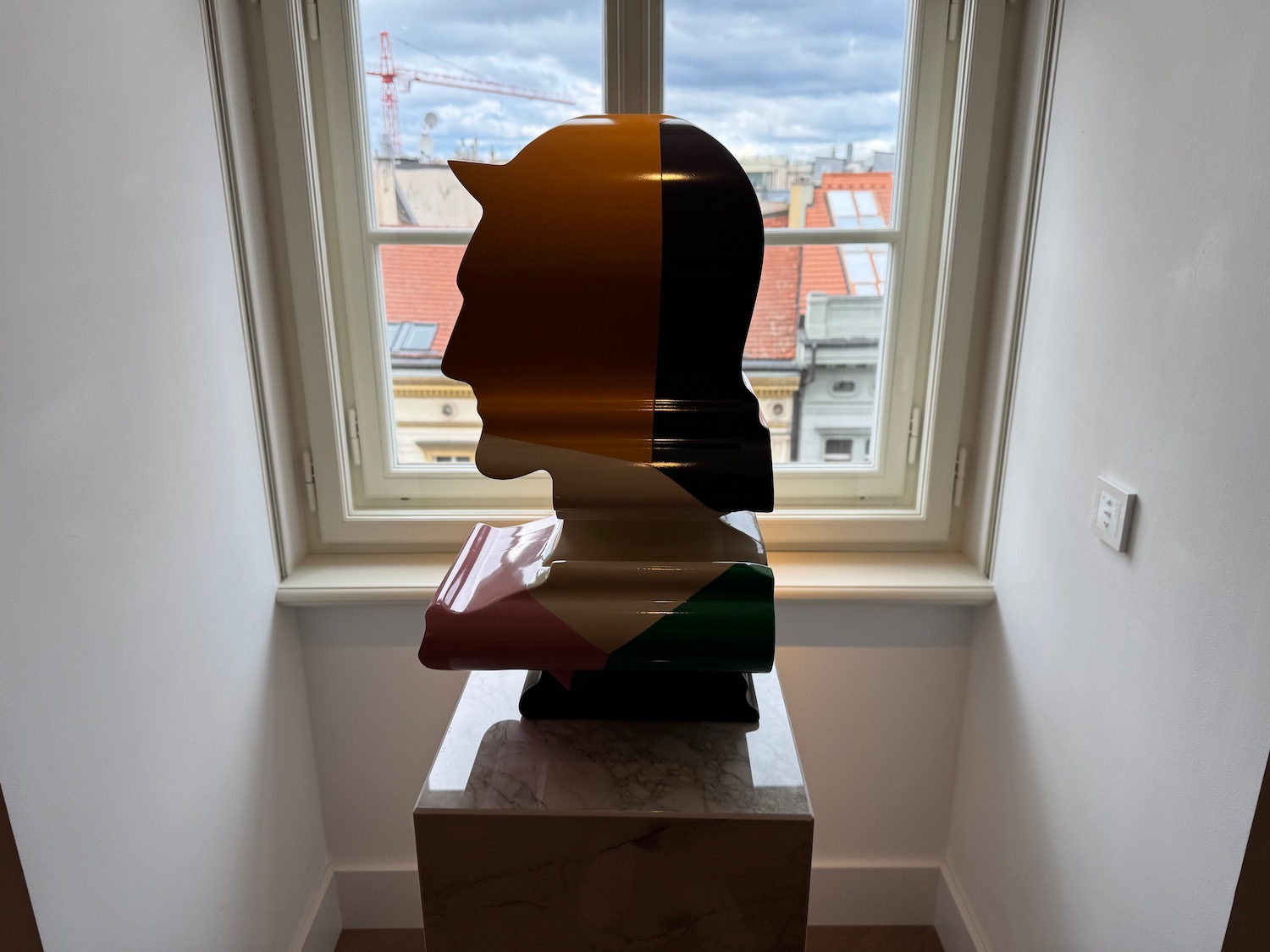a statue of a man's head in a room with a window