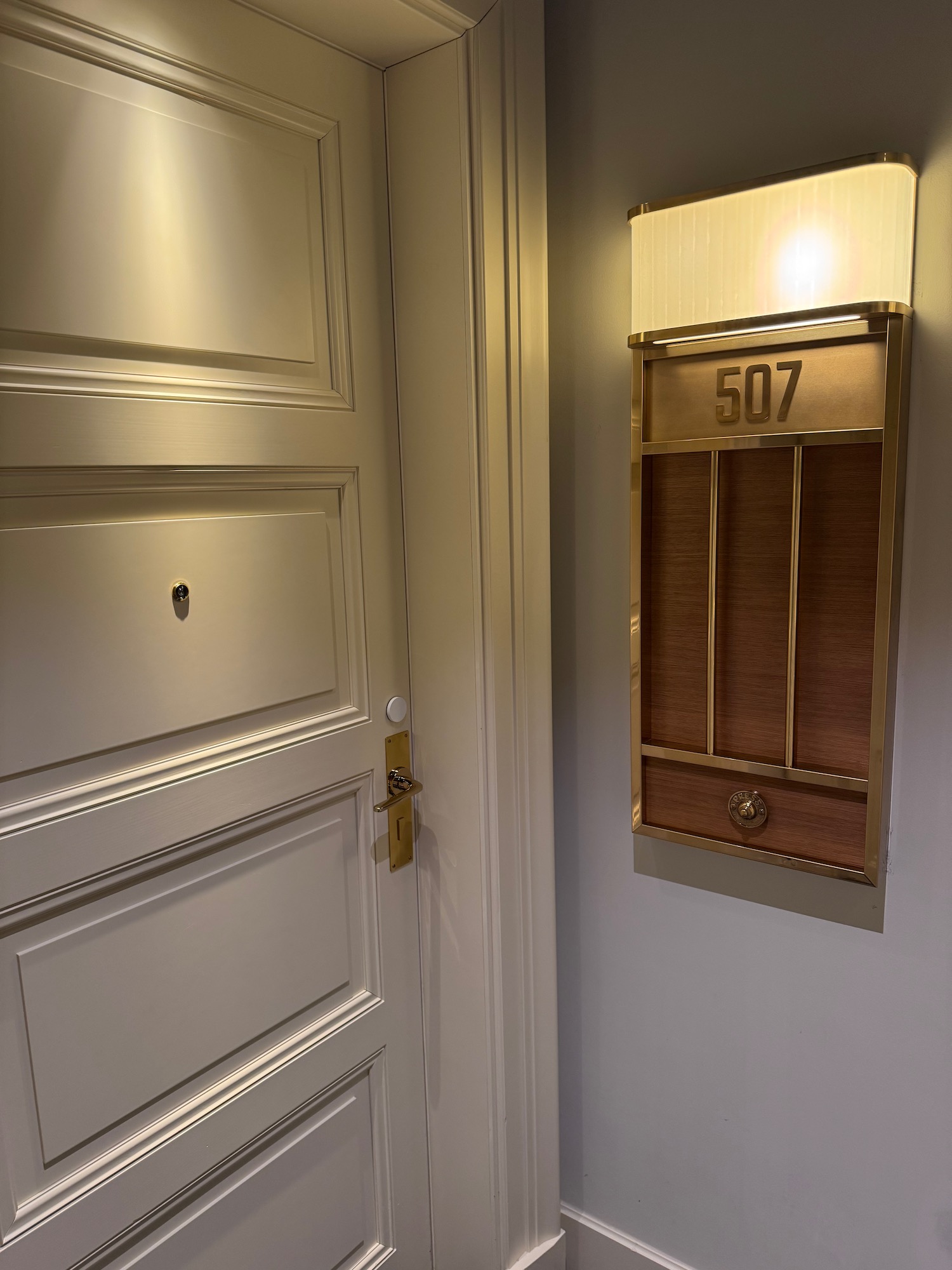 a door with a light on the wall