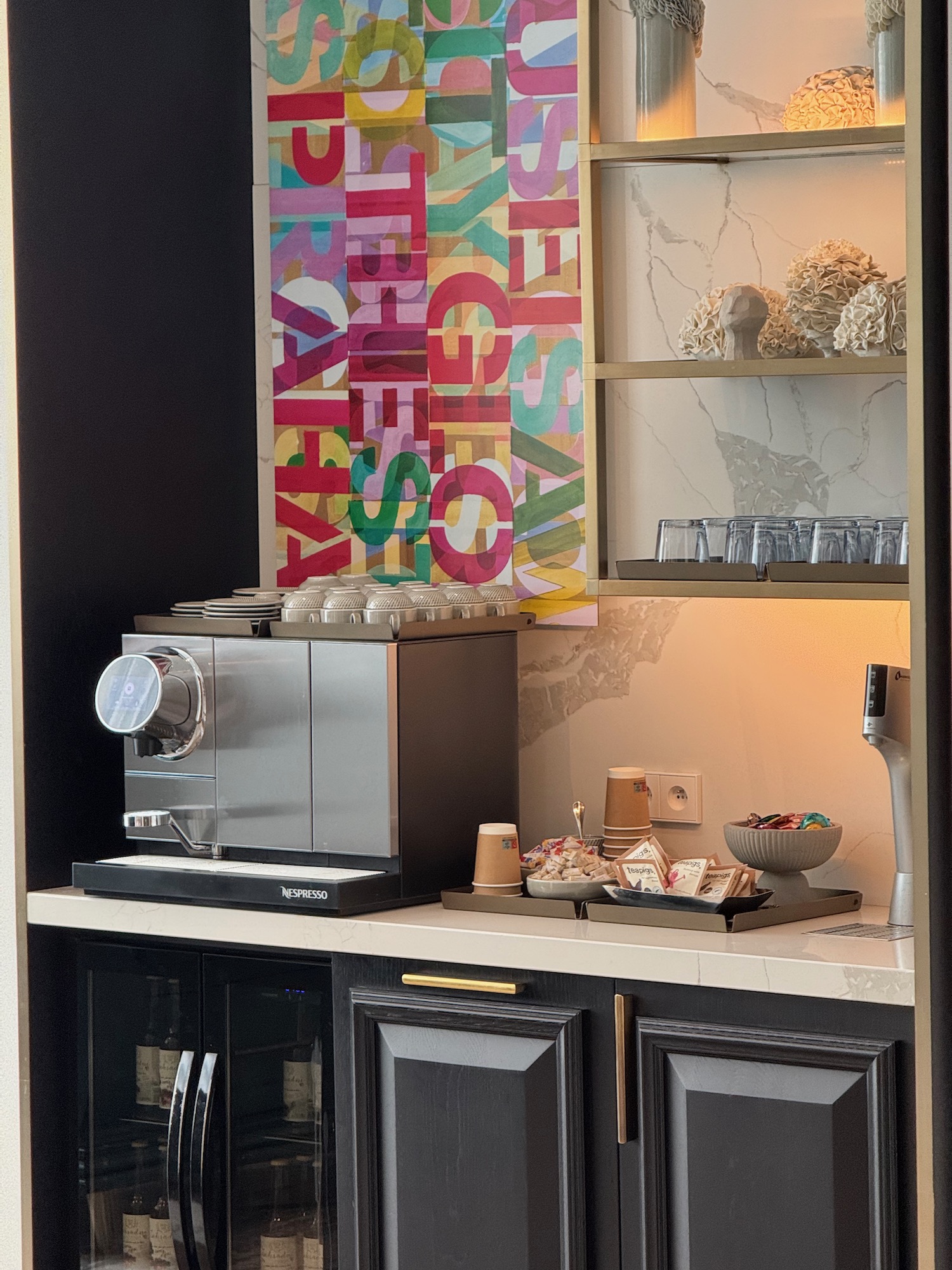 a counter with a coffee machine and a poster