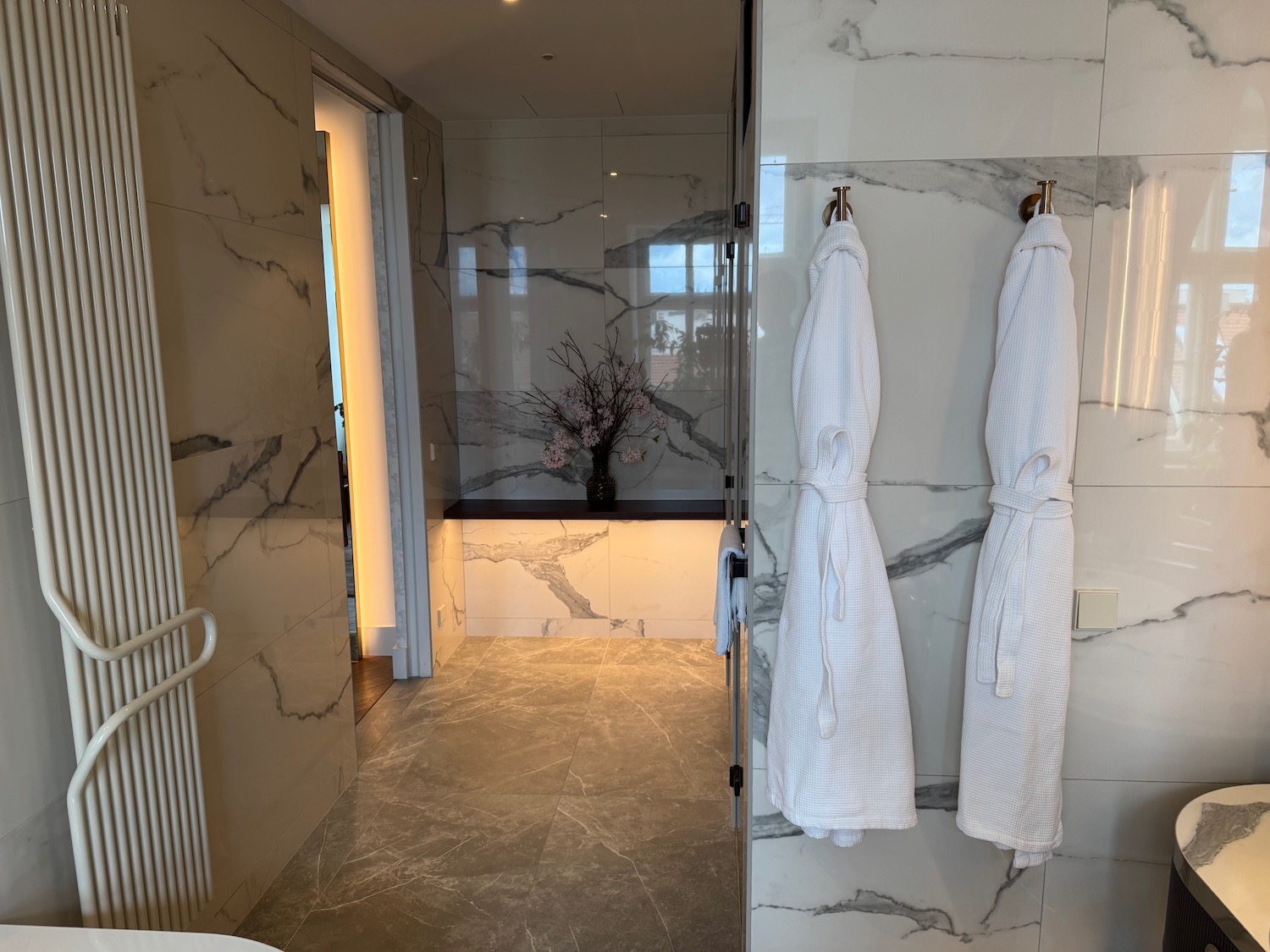 a bathroom with marble walls and white towels