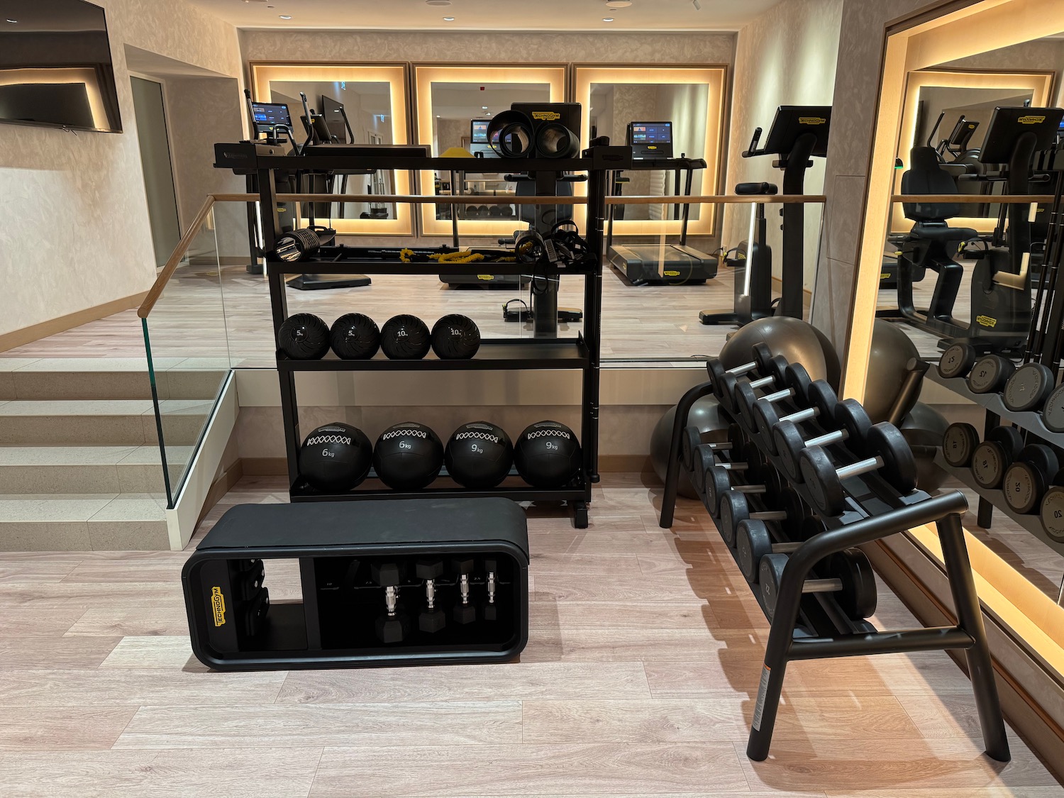 a room with a mirror and exercise equipment