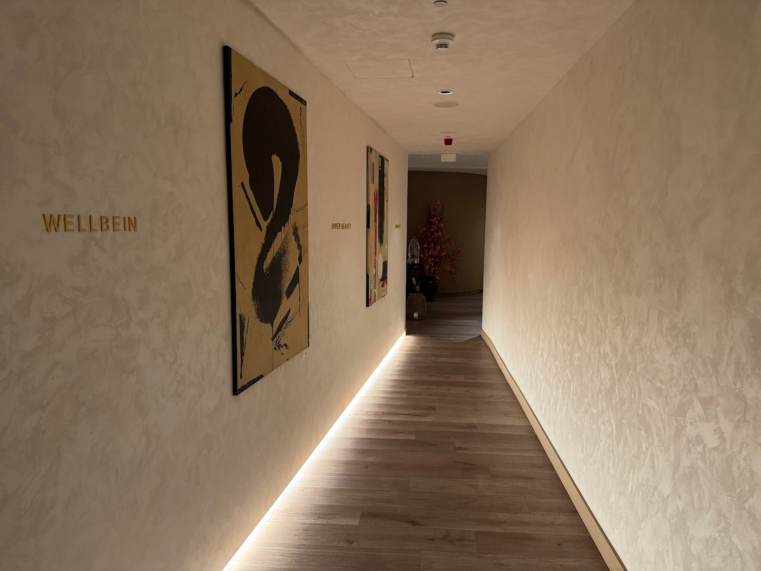 a hallway with art on the wall