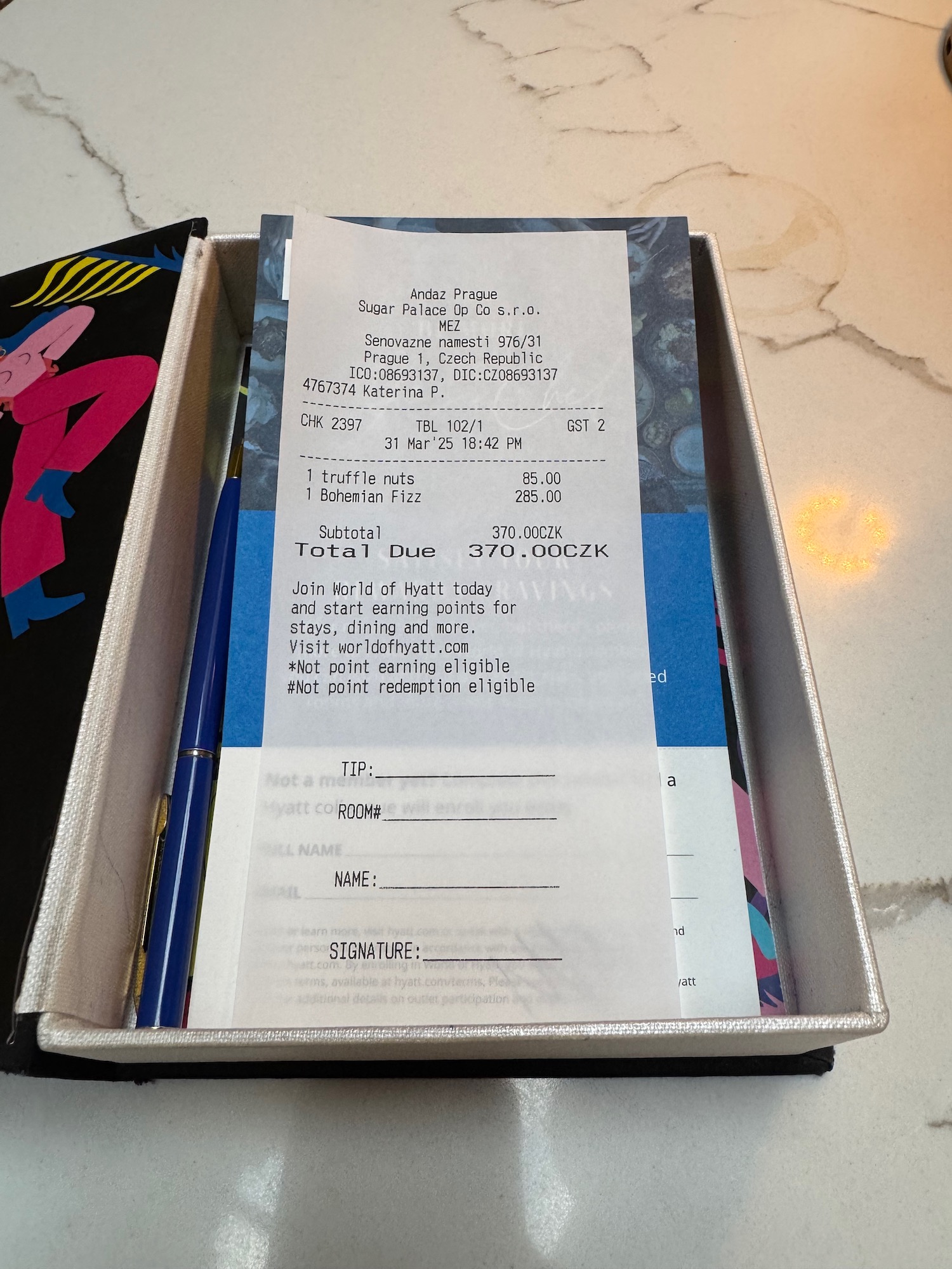 a box with a pen and a receipt