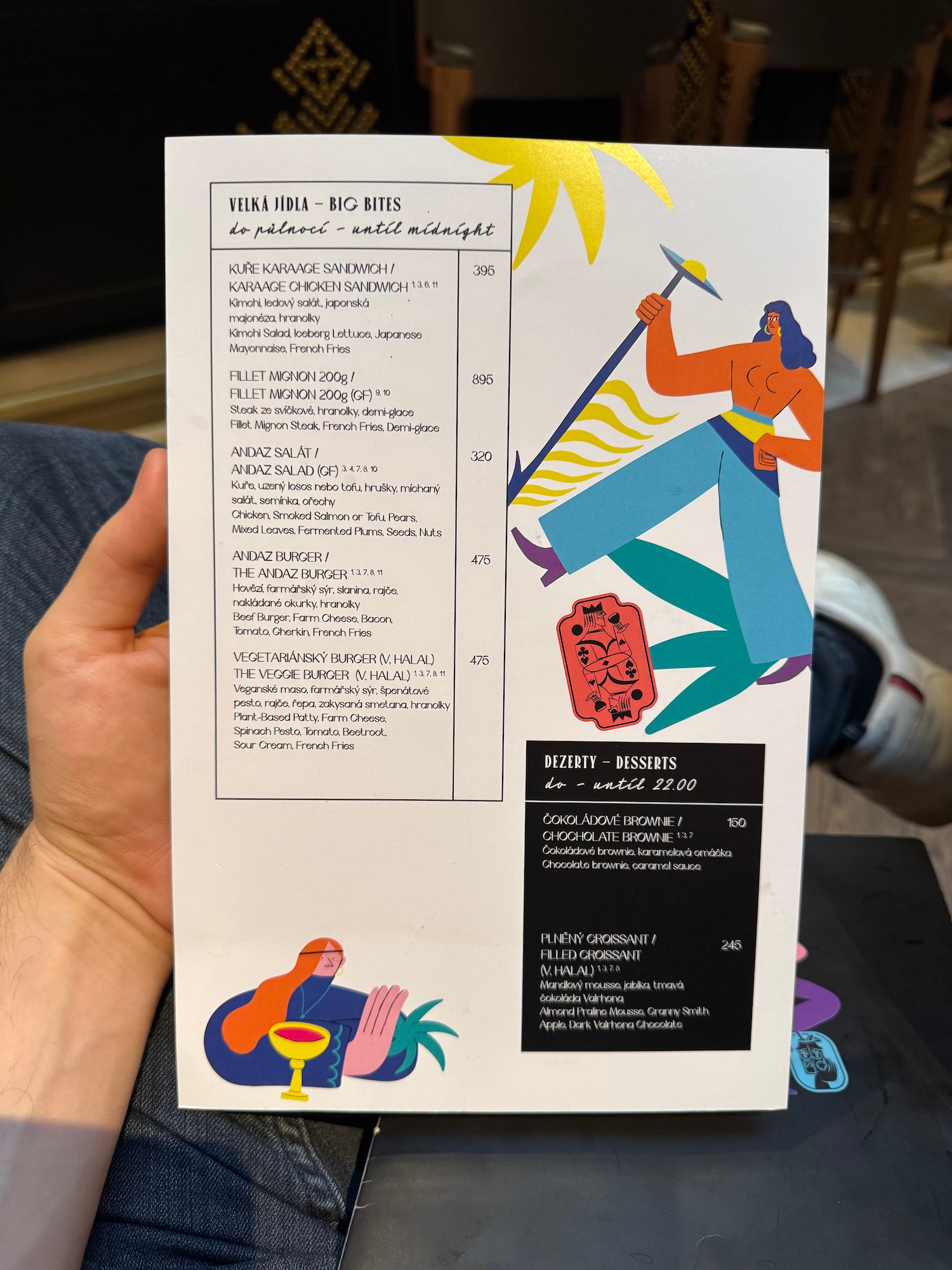 a hand holding a menu