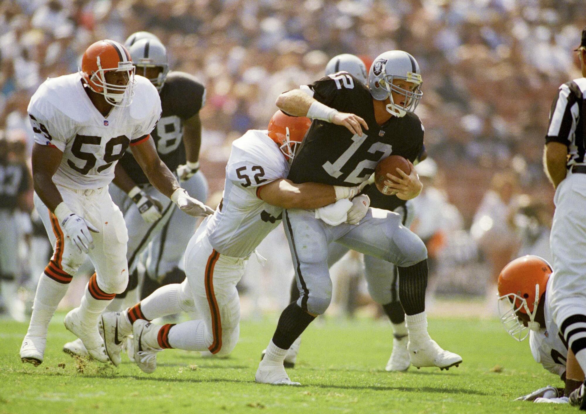 Raiders quarterback Todd Marinovich is tackled by Browns linebacker Richard Brown on Sept. 20, 1992.