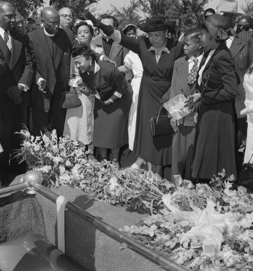 Mamie Till-Mobley is seen crying as her son's body is lowered into the grave after the four-day, open casket funeral.
