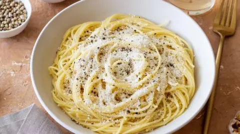 Getty Images pasta in a bowl with cheese and pepper