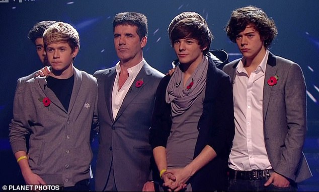 Harry (far right) with his One Direction band mates and X Factor judge Simon Cowell back in 2010