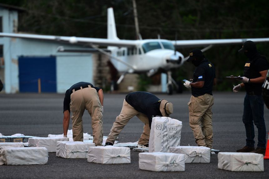 Honduran criminal investigators with packages of cocaine seized from a plane coming from Venezuela, at the Hernan Acosta Mejia air base in Tegucigalpa, Honduras, in 2020.