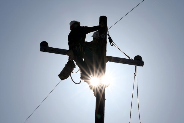 File photo of a PG&E crew replacing a broken post near Las Trampas Regional Wilderness Park in San Ramon. (Ray Chavez/Bay Area News Group)