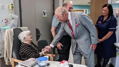 Reuters The King shaking hands with Jacqueline Page, a patient in hospital