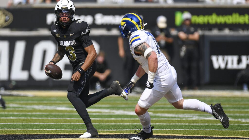 Quarterback Kaidon Salter runs the ball as Dillon Trainer pursues him.