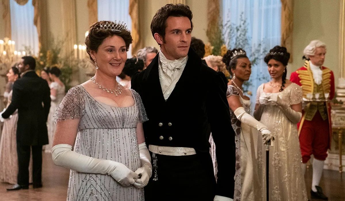 a man and a woman standing together dressed up 