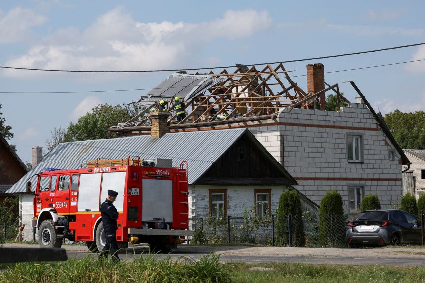 Firefighters work on the destroyed roof of a house, after Russian drones violated Polish airspace during an attack on Ukraine, with some being shot down by Poland with the backing from its NATO allies, in Wyryki-Wola, Lublin Voivodeship, Poland, September 10, 2025.
