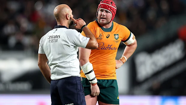 Referee Andrea Piardi talks with Harry Wilson of Australia.