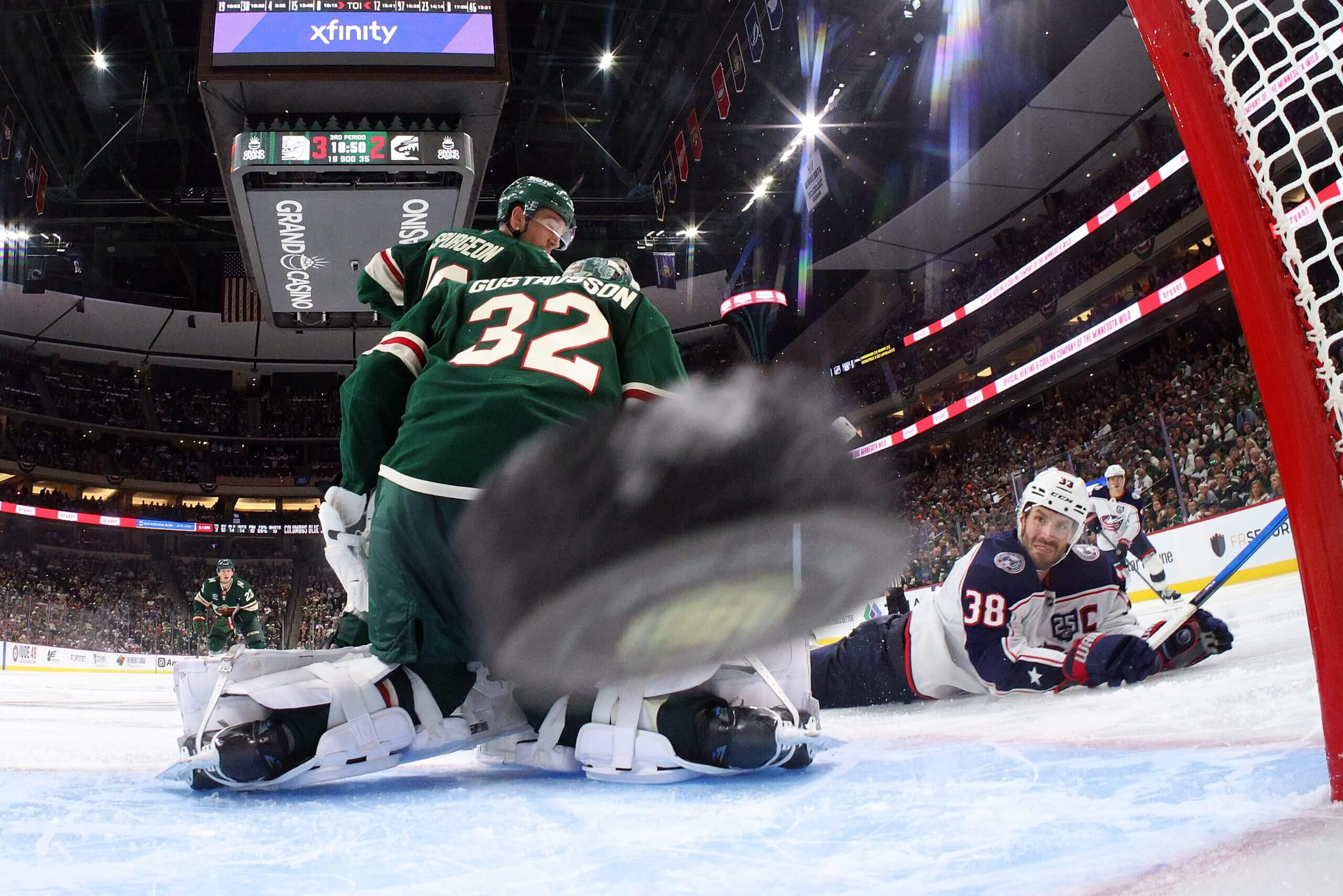 The puck, front and center of the picture, flies into the net behind Filip Gustavsson.