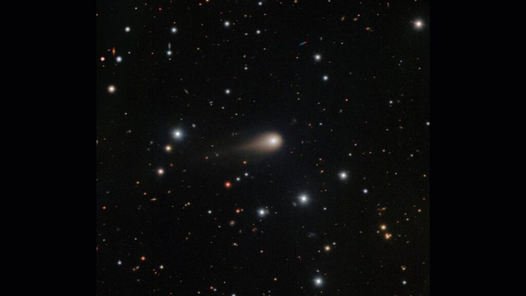 A streak of white shows interstellar comet 3I/ATLAS in the center of a starry night sky