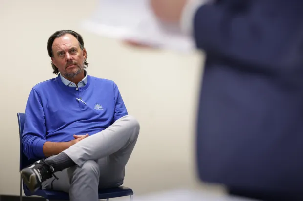 Dan Proft listens to questions from attorney David Fox, right, during a hearing of the State Board of Elections after Illinois Democrats filed a complaint against the GOP strategist for alleged illegal election coordination with former GOP gubernatorial nominee Darren Bailey on April 29, 2024, in Chicago. The illegal coordination allegedly happened when Proft ran the People Who Play By The Rules PAC. (Stacey Wescott/Chicago Tribune)