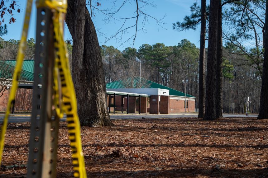 NEWPORT NEWS, VA - JANUARY 07: Police tape hangs from a sign post outside Richneck Elementary School following a shooting on January 7, 2023 in Newport News, Virginia. A 6-year-old student was taken into custody after reportedly shooting a teacher during an altercation in a classroom at Richneck Elementary School on Friday. The teacher, a woman in her 30s, suffered