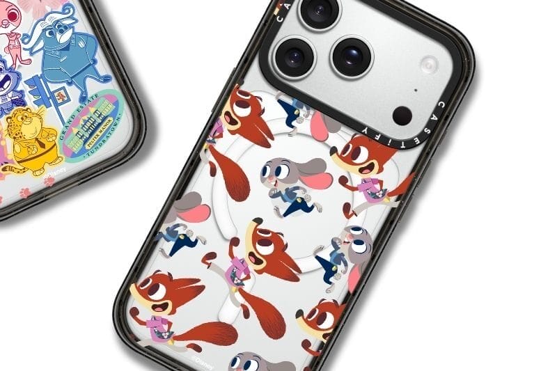 Two phone cases with vibrant Zootopia 2 designs, reminiscent of Disney Parks merchandise near iconic castles like Cinderella’s.