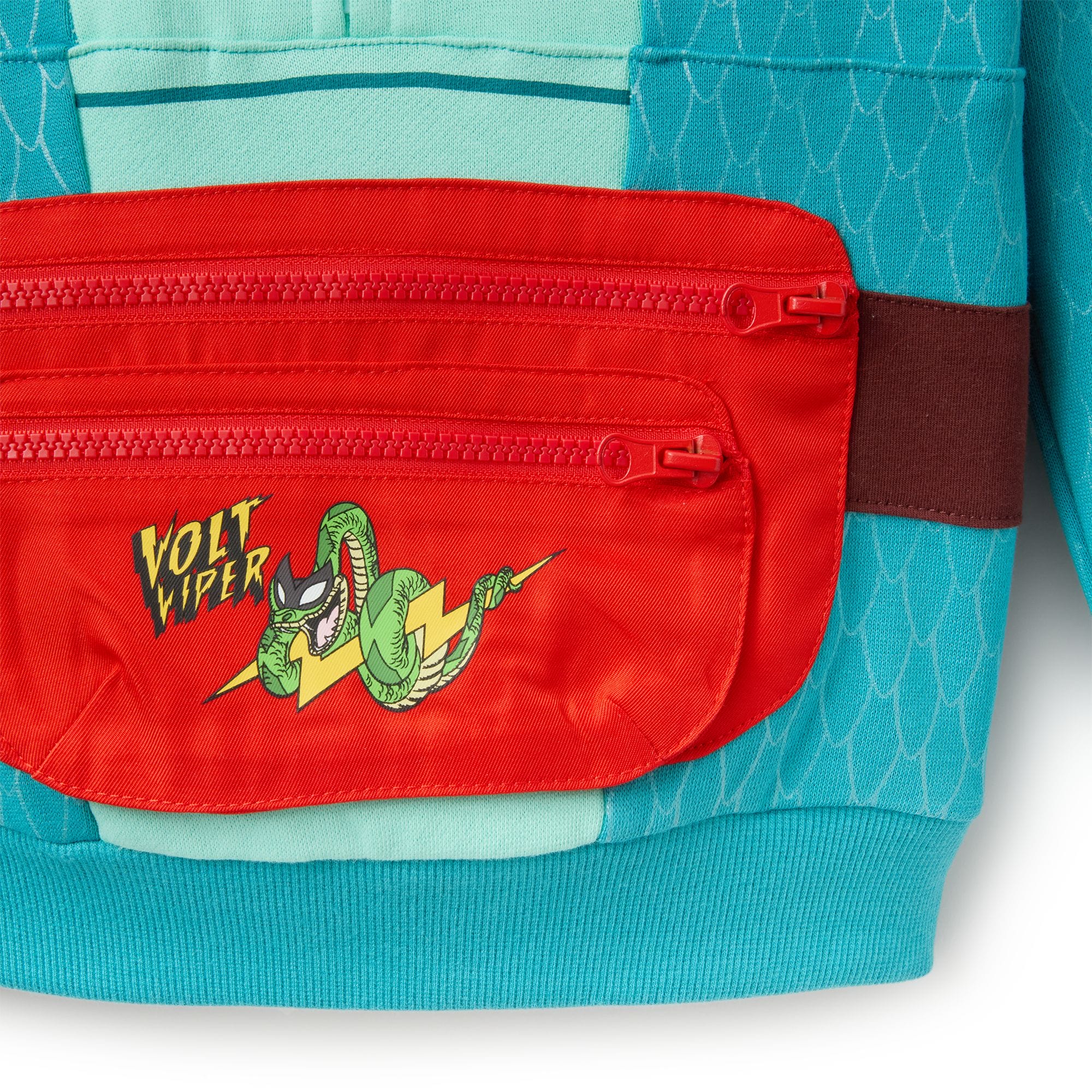 Close-up of a red pocket on teal fabric showing a cartoon snake and 