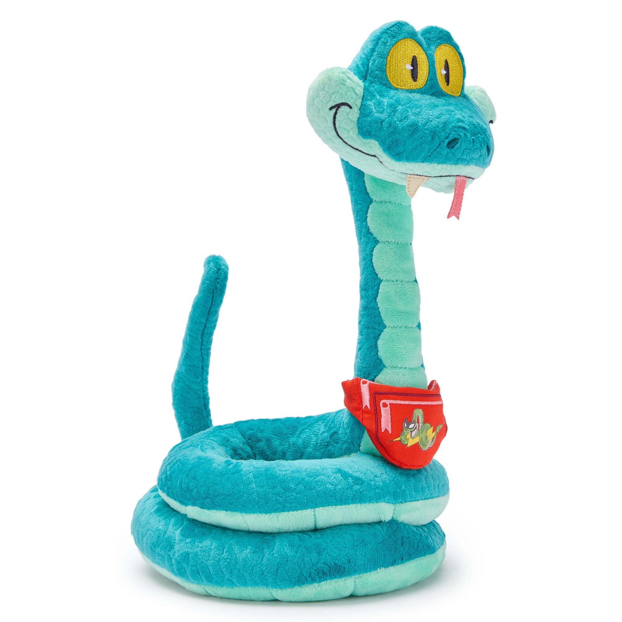 Plush turquoise snake toy with yellow eyes, red tongue, and Disney Store pouch sits upright—no castle like those in Disney Parks shown.