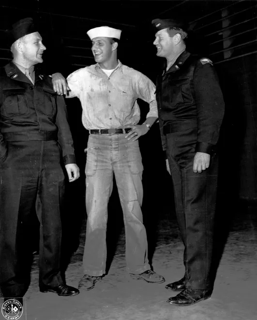 Whitey Kurowski (L) and Red Barrett (R) are greeted by their former teammate Stan Musial who is in the United States Navy, upon their arrival at ATC Terminal, Honolulu, Hawaii circa 1945. The three played in baseball games to entertain troops.