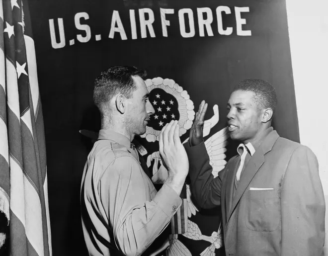 Baseball center fielder Willie Mays is inducted by Captain William F. Donegan Jr during a swearing ceremony at the First Army examining station on 39th Whitehall Street, New York on May 29, 1952. Mays was stationed in Virginia from 1952-54.