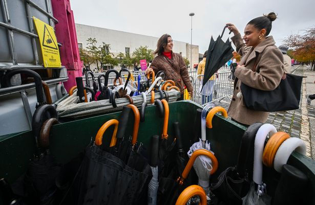 Web Summit attendees retrieve their non-foldable umbrellas as Storm Claudia hit Lisbon