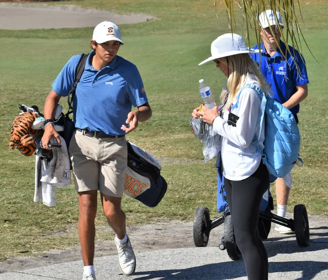 Charlie Woods' mother Elin Nordegren offers him water and snacks in between holes at the Class 1A state championship on Nov. 15, 2025.