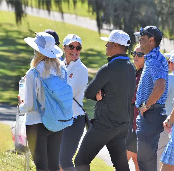 Tiger Woods and fellow Benjamin friends and family share a laugh as they converse in the gallery and watch the Buccaneers play in the Class 1A state championship on Nov. 15, 2025.