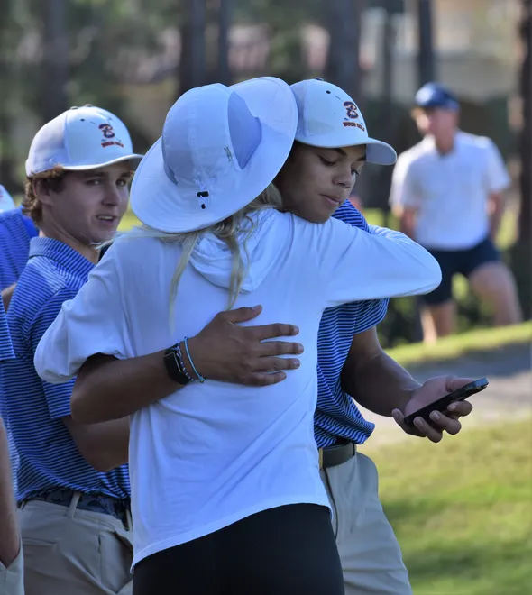 Charlie Woods embraces mother Elin Nordegren after he finished hole 18 during the Class 1A state championship on Nov. 15, 2025.