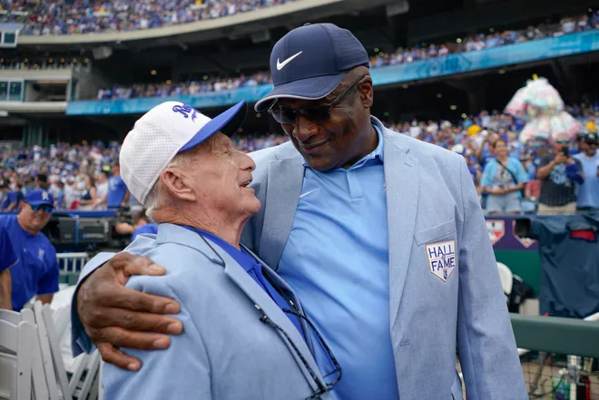 In 2024, longtime groundskeeper George Toma talks with Bo Jackson prior to a game between the Cleveland Guardians and Kansas City Royals at Kauffman Stadium.