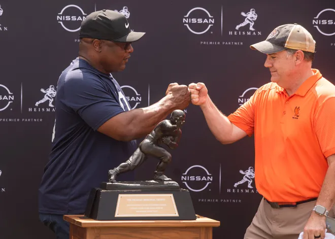 Auburn Heisman winner Bo Jackson poses for photos with fans before an Auburn football game at Jordan-Hare Stadium in Auburn, Ala., on Sept. 17, 2022.