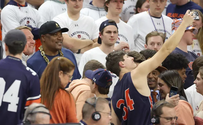 Former Auburn Tigers football player Bo Jackson poses for selfies during an Auburn basketball game in 2024.