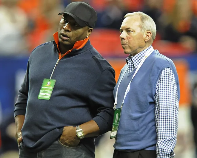 Auburn Heisman Trophy winners Bo Jackson, left, and Pat Sullivan, right, watch Auburn warm up before the SEC Championship Game at Georgia Dome in Atlanta, Ga. on Saturday December 7, 2013. (Mickey Welsh, Montgomery Advertiser)