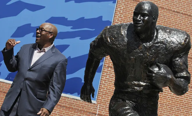 Bo Jackson poses beside a statue of himself during the unveiling ceremony for the Heisman statues at Jordan Hare Stadium in Auburn, Ala. on Saturday April 14, 2012.(Montgomery Advertiser, Mickey Welsh)