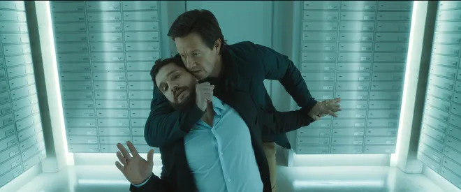 Ex-assassin Dan (Mark Wahlberg, right) runs into an old enemy on a London family vacation in the action sequel