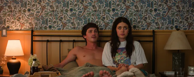 Iris (Molly Gordon, right) takes Isaac's (Logan Lerman) lack of commitment into her own hands in