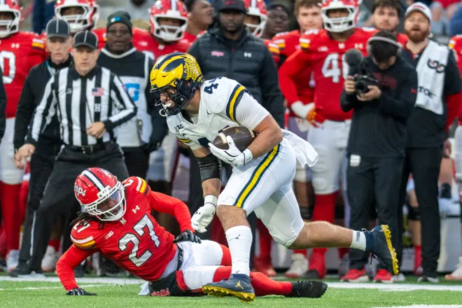 Michigan Wolverines tight end Max Bredeson (44) runs by Maryland Terrapins defensive back La'Khi Roland (27) after a first half catch at SECU Stadium in College Park, Maryland on Saturday, Nov. 22, 2025.