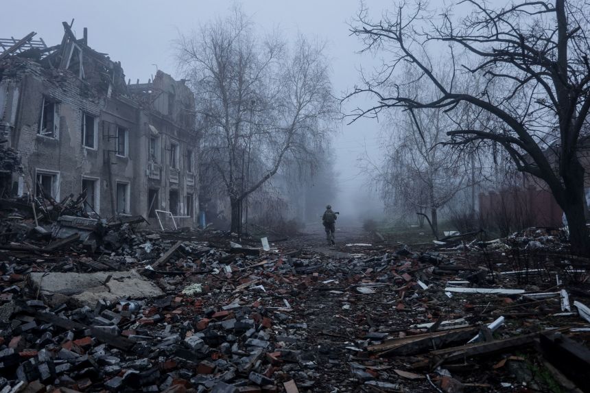A Ukrainian serviceman walks near apartment buildings damaged by Russian military strike in the frontline town of Kostiantynivka, in Ukraine's Donetsk region, on November 28.