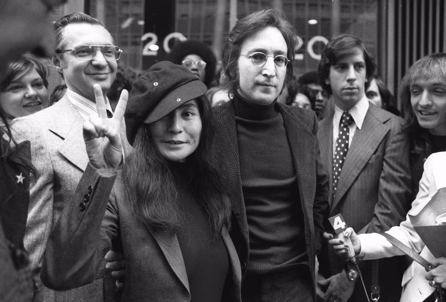 In this April 18, 1972 file photo, John Lennon and his wife, Yoko Ono, leave a US Immigration hearing in New York City. 