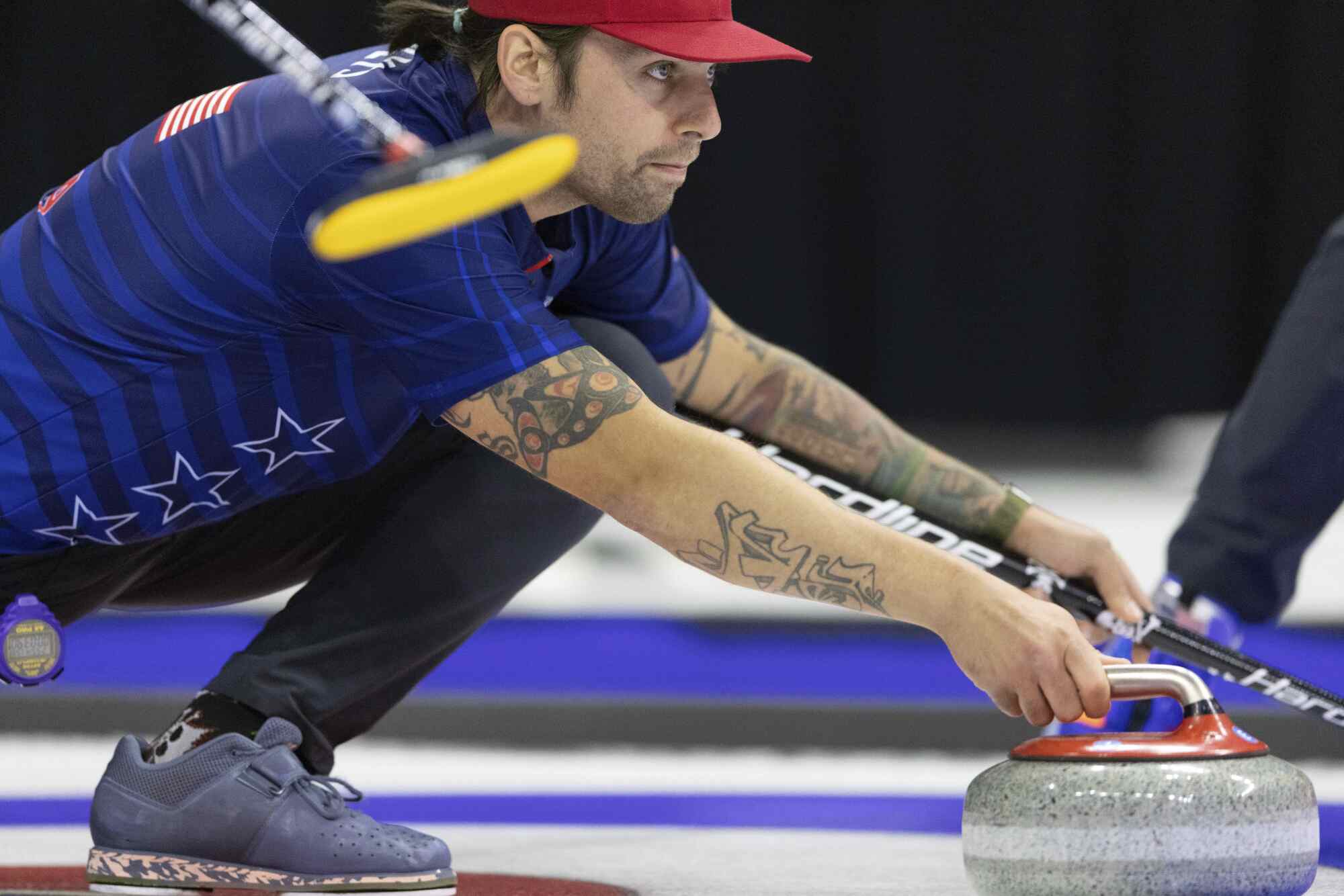 Team Shuster's Chris Plys throws the rock during the U.S. Olympic curling team trials in Omaha, Neb., on Nov. 20, 2021. 