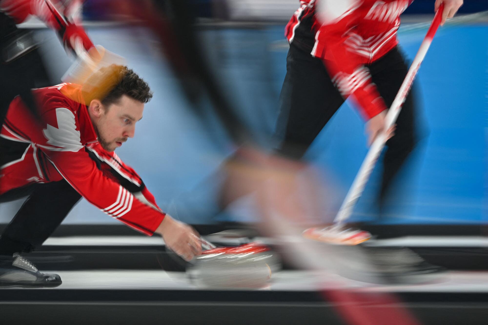 Canada's Brett Gallant curls the stone during an Olympic match.